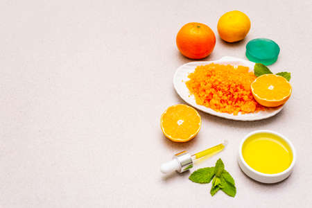 Healthy self-care. Minimalistic organic lifestyle. Comfort and natural pharmacy. Sea salt, herbal oil, mandarin and fresh mint leaves. Bowls, stone concrete background, copy spaceの写真素材