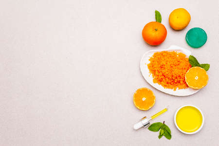 Healthy self-care. Minimalistic organic lifestyle. Comfort and natural pharmacy. Sea salt, herbal oil, mandarin and fresh mint leaves. Bowls, stone concrete background, copy space, top viewの写真素材