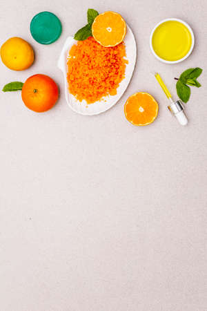 Healthy self-care. Minimalistic organic lifestyle. Comfort and natural pharmacy. Sea salt, herbal oil, mandarin and fresh mint leaves. Bowls, stone concrete background, copy spaceの写真素材