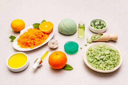 Healthy self-care. Minimalistic organic lifestyle. Comfort and natural pharmacy. Set of sea salt, herbal oil, mandarin and fresh mint leaves. Bowls, stone concrete backgroundの写真素材