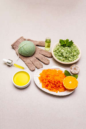 Healthy self-care. Minimalistic organic lifestyle. Comfort and natural pharmacy. Set of sea salt, herbal oil, glove, mandarin and fresh mint leaves. Bowls, stone concrete background, copy spaceの写真素材
