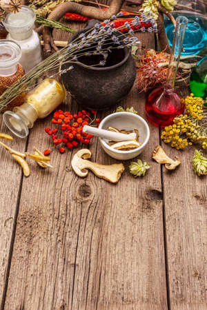 Witch's Laboratory. Alchemical equipment, apothecary treatment. Mortar and pestle, bottles, powders, dry herbs. Halloween concept, old wooden boards background, copy space, top viewの写真素材