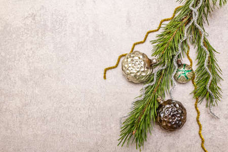 Vintage Christmas tree toys. New Year holiday concept. Evergreen pine branch, stone concrete background, copy space, top viewの写真素材