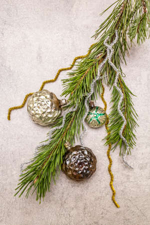 Vintage Christmas tree toys. New Year holiday concept. Evergreen pine branch, stone concrete background, copy space, top viewの写真素材