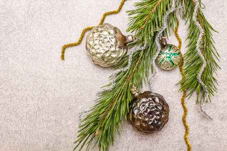 Vintage Christmas tree toys. New Year holiday concept. Evergreen pine branch, stone concrete background, copy space, top viewの写真素材