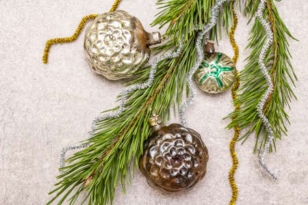 Vintage Christmas tree toys. New Year holiday concept. Evergreen pine branch, stone concrete background, copy space, top view, close upの写真素材