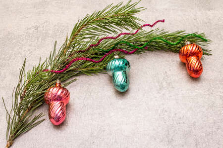 Vintage Christmas tree toys. New Year holiday concept. Evergreen pine branch, stone concrete background, copy spaceの写真素材