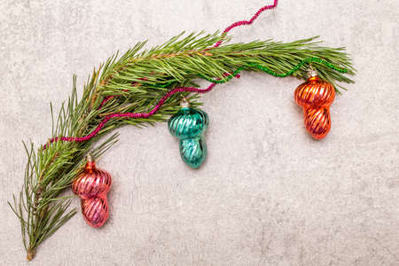 Vintage Christmas tree toys. New Year holiday concept. Evergreen pine branch, stone concrete background, copy space, top viewの写真素材