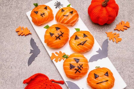 Funny Halloween Sushi Pumpkins Jack o Lantern, Sushi Monsters. Temari sushi, sushi balls. Healthy food for kids. Bats, leaves, stone concrete background, close upの写真素材