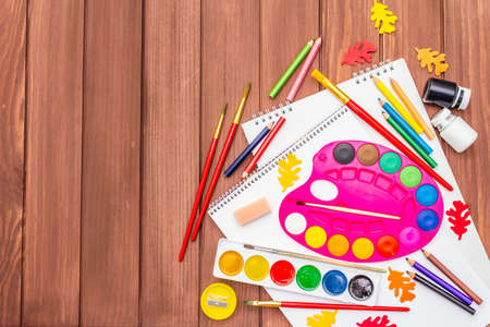 Back to school concept. School education supplies on brown wooden boards background, flat , top viewの写真素材