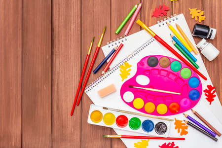 Back to school concept. School education supplies on brown wooden boards background, flat , top viewの写真素材