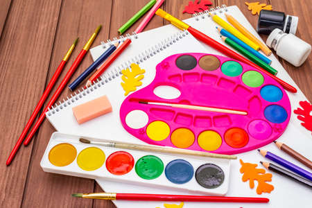 Back to school concept. School education supplies on brown wooden boards background, flat lay, close upの写真素材