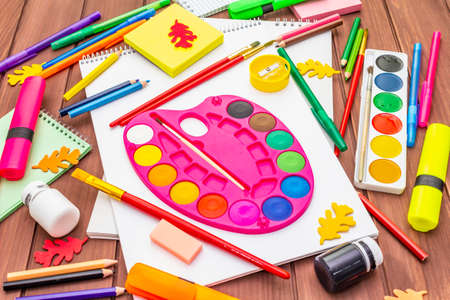 Back to school concept. School education supplies on brown wooden boards background, flat lay, close upの写真素材