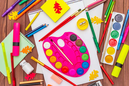 Back to school concept. School education supplies on brown wooden boards background, flat , top viewの写真素材