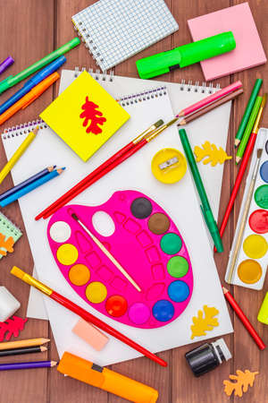 Back to school concept. School education supplies on brown wooden boards background, flat , top viewの写真素材