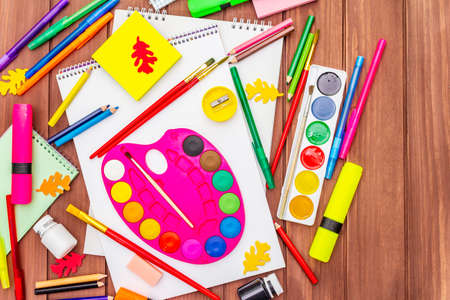Back to school concept. School education supplies on brown wooden boards background, flat , top viewの写真素材