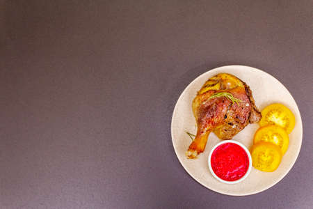 Crusty roasted duck leg. Traditional French food confit preparation. Served with cranberry sauce,...