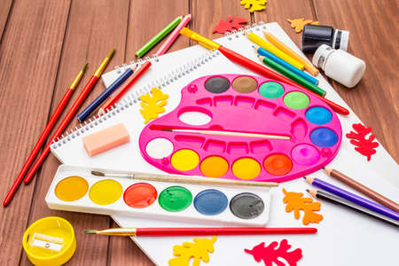 Back to school concept. School education supplies on brown wooden boards background, flat layの写真素材