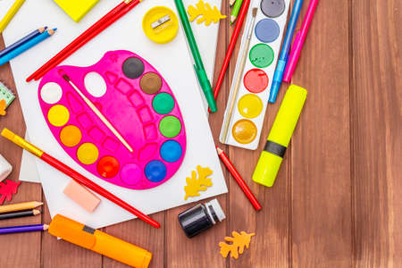 Back to school concept. School education supplies on brown wooden boards background, flat , top viewの写真素材