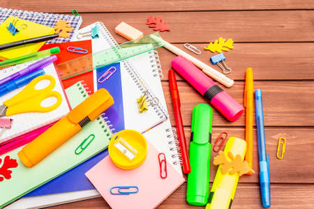 Back to school concept. School education supplies on brown wooden boards background, flat layの写真素材