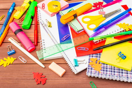 Back to school concept. School education supplies on brown wooden boards background, flat layの写真素材