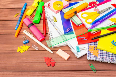 Back to school concept. School education supplies on brown wooden boards background, flat lay, copy spaceの写真素材