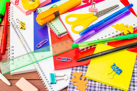 Back to school concept. School education supplies on brown wooden boards background, flat lay, close upの写真素材