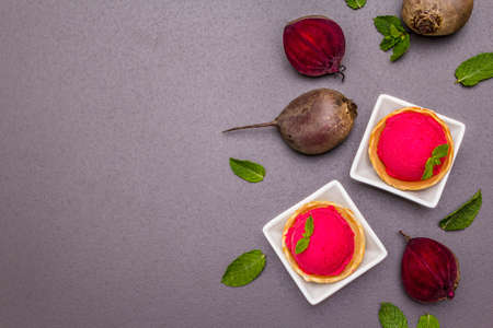 Beet ice cream, sorbet, gelato. Summer healthy refreshment dessert. Vegetarian (vegan) trendy food concept. With fresh vegetables and mint. Stone concrete background, copy space, top viewの写真素材