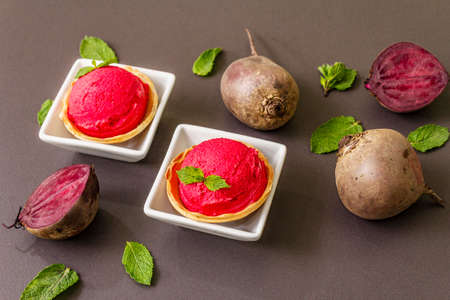Beet ice cream, sorbet, gelato. Summer healthy refreshment dessert. Vegetarian (vegan) trendy food concept. With fresh vegetables and mint. Stone concrete backgroundの写真素材