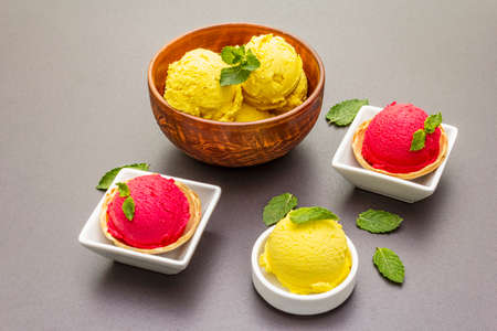 Assorted of beet and tomato ice cream, sorbet, gelato, mint. Summer healthy refreshment dessert. Vegetarian (vegan) trendy food concept. Stone concrete backgroundの写真素材