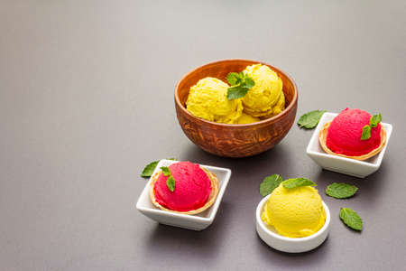 Assorted of beet and tomato ice cream, sorbet, gelato, mint. Summer healthy refreshment dessert. Vegetarian (vegan) trendy food concept. Stone concrete background, copy spaceの写真素材