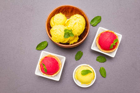 Assorted of beet and tomato ice cream, sorbet, gelato, mint. Summer healthy refreshment dessert. Vegetarian (vegan) trendy food concept. Stone concrete background, copy space, top viewの写真素材