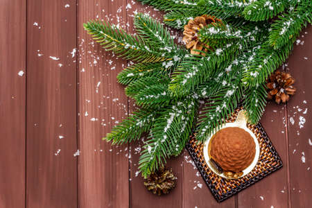 Festive dessert in the shape of a Christmas fir cone. New Year sweet treat concept. Wooden boards background, copy space, top viewの写真素材