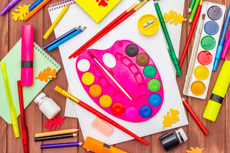 Back to school concept. School education supplies on brown wooden boards background, flat , top viewの写真素材