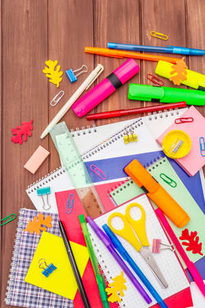 Back to school concept. School education supplies on brown wooden boards background, flat lay, top viewの写真素材