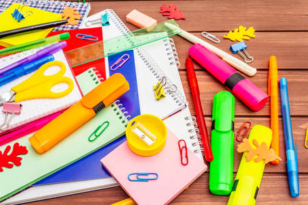 Back to school concept. School education supplies on brown wooden boards background, flat lay, close upの写真素材