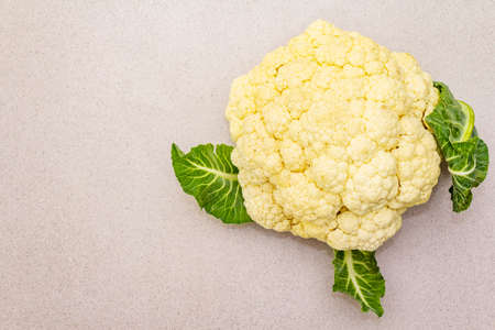 Fresh raw cauliflower. Source of vitamins and minerals. Ingredient for preparing healthy vegan (vegetarian) food. On a stone concrete background, copy space, top viewの写真素材
