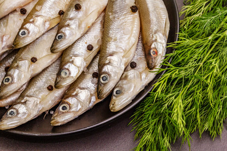 Raw sea fish smelt, sardines, anchovies, capelin with the scent of fresh cucumber ready for cooking....