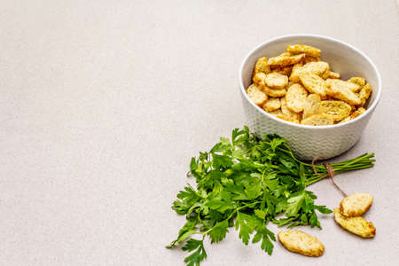 Fresh croutons for hot autumn cream soups. Traditional fast crisp snack with fresh parsley. In...