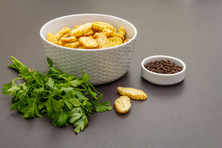 Fresh croutons for hot autumn cream soups. Traditional fast crisp snack with fresh parsley and black...