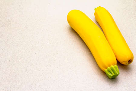 Bright yellow zucchini. Fresh vegetables for cooking. Harvest on stone background, isolated, copy spaceの写真素材