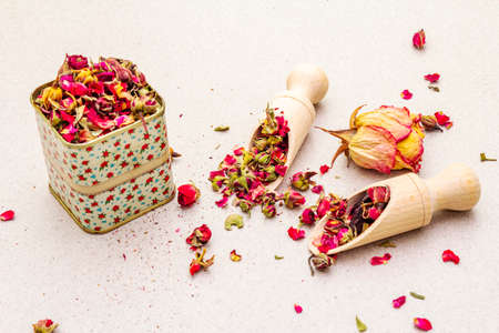 Traditional Turkish tea from rosebuds. Fragrant petals and flowers in wooden shovels and tin tea...