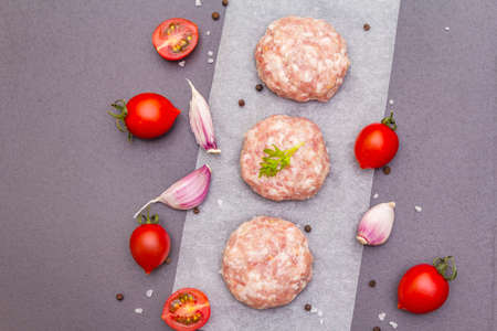 Raw fresh pork cutlets with spices and vegetables Healthy eating concept, animal proteins and...