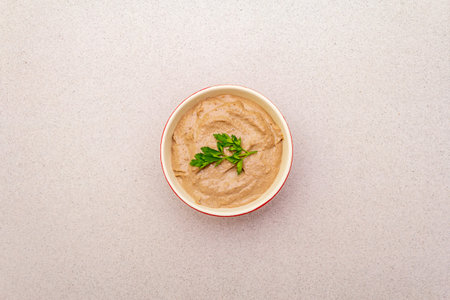 Chicken liver pate with butter and fresh parsley. Concept of traditional french food. On stone...