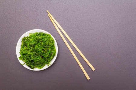 Traditional Japanese Hiyashi Wakame Chuka seaweed salad with sesame seeds. Healthy food concept...