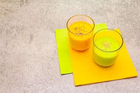 Organic cucumber and carrot smoothies with sesame and chia seeds. Healthy diet concept. On a stone background, copy spaceの写真素材