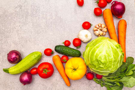 Assortment fresh organic vegetables. Food cooking stone background. Healthy vegetarian (vegan) eating concept, top view copy space flat layの写真素材