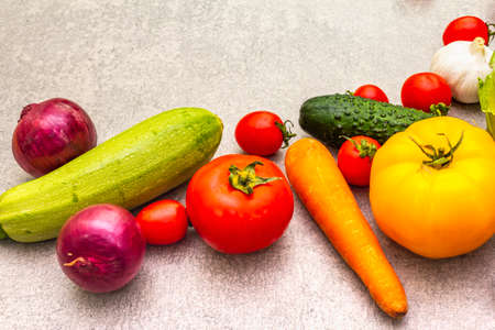 Assortment fresh organic vegetables. Food cooking stone background. Healthy vegetarian (vegan) eating conceptの写真素材