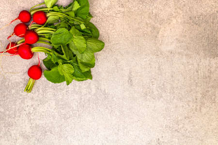 Fresh organic radish. Food cooking stone background. Healthy vegetarian (vegan) eating concept, top view, copy space, flat layの写真素材