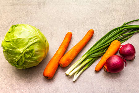 Assortment fresh organic vegetables. Food cooking stone background. Ingredients for cole slaw salad. Healthy vegetarian (vegan) eating concept, copy spaceの写真素材